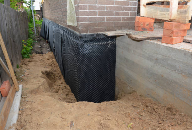 Happy homeowners after waterproofing job in Boston
